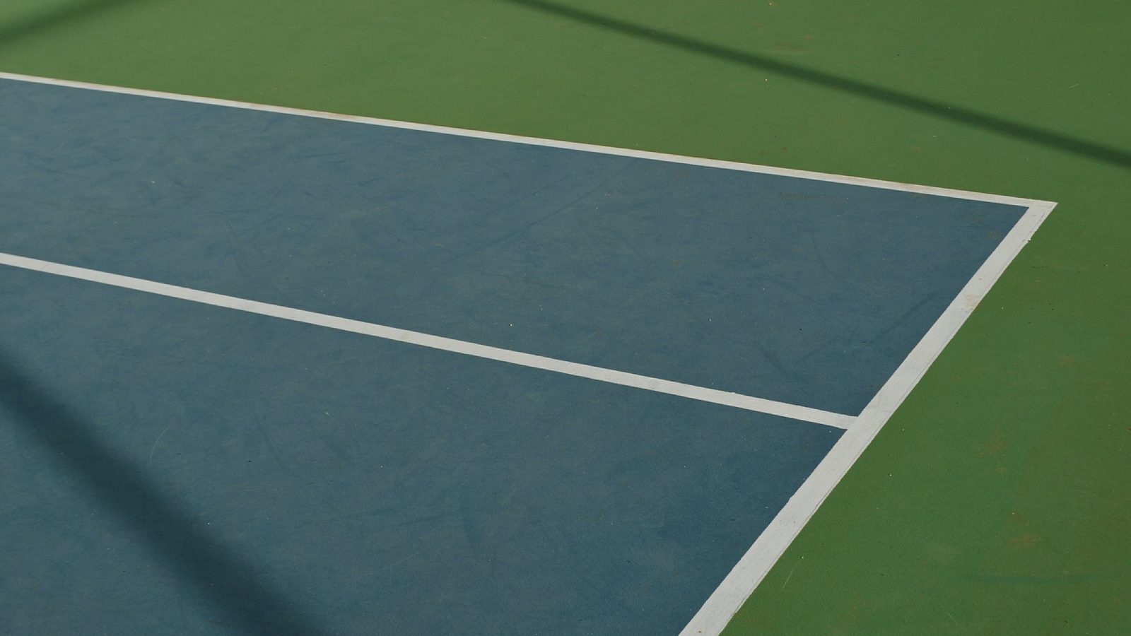 Fresh white service lines on a blue and green San Diego hard court